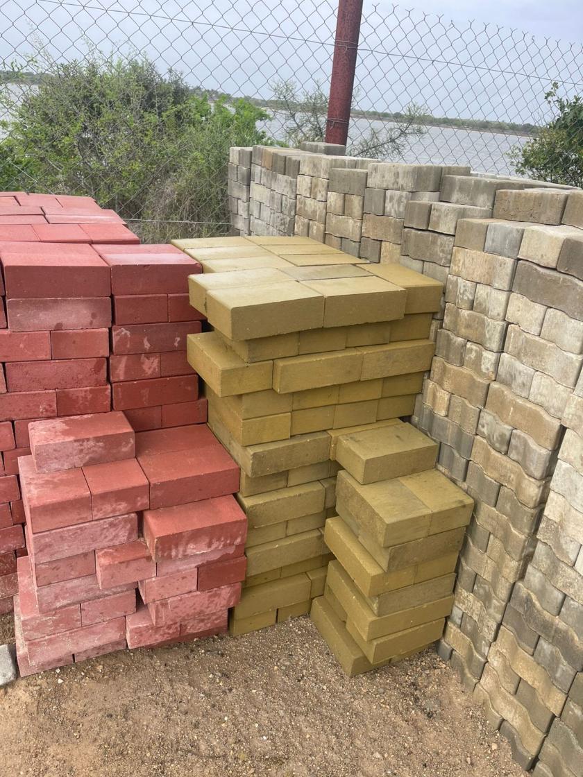 Red and yellow paving bricks stacked in the yard