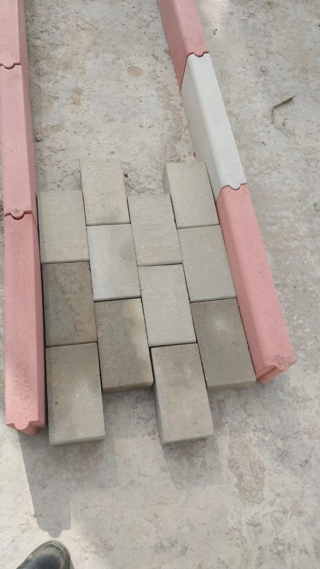 Paving bricks laid between red and white kerbs