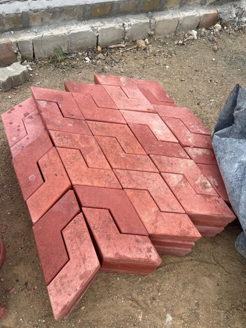 Red L-shaped pavers stacked on a pallet